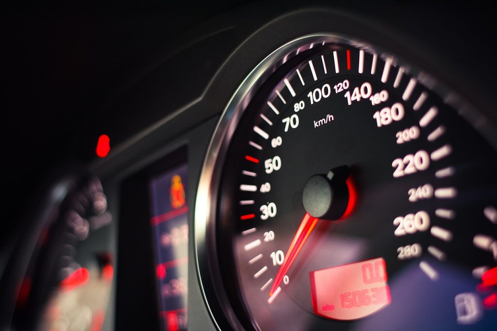 a car dashboard and close up of the speedometer